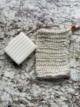 Load image into Gallery viewer, picture of beige sisal exfoliating bag with brown bead drawstring beside white lavender vanilla Cleansing Bar for size comparison on tan marble background
